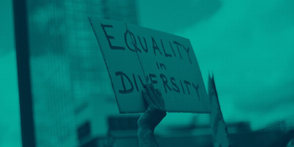 Protestor with a sign saying 'Equality & Diversity"